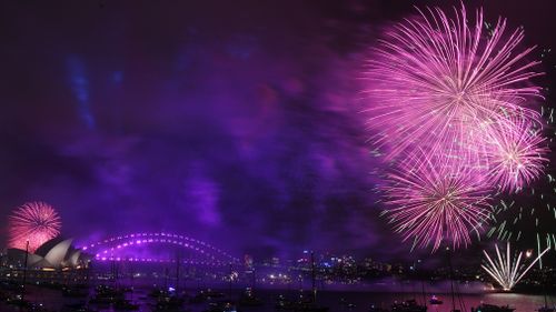 Fireworks explode over Sydney Harbour during New Year's Eve celebrations in Sydney. (AAP)