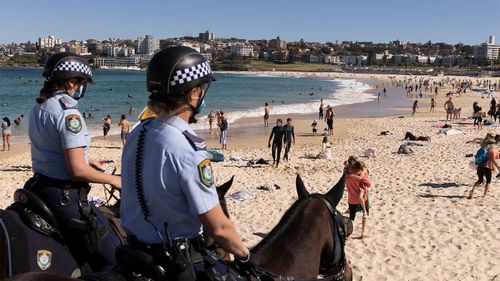 Mounted Police patrol at Bondi Beach as part of public health order compliance operations.