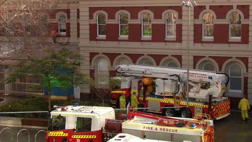 A naked, bloodied man stuck on a roof brought a Perth street into lockdown for more than four hours.