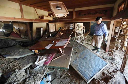 In Kurashiki, one resident tries to clean his own house left devastated by the floodwaters. Picture: AP