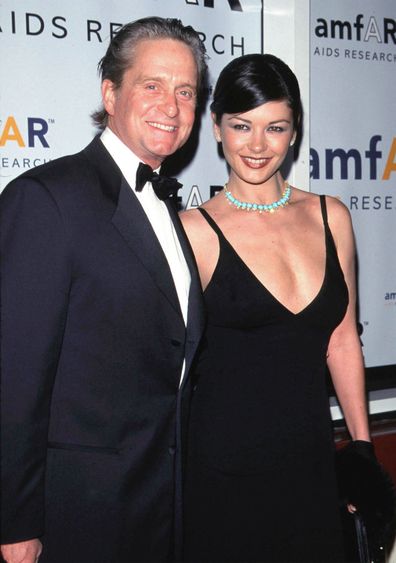 Michael Douglas and his fiancee Catherine Zeta-Jones smile at an "AMFAR" benefit November 30, 1999 in New York. 