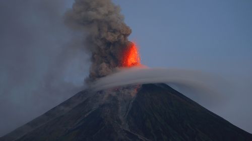 Mayon volcano spews red-hot lava in another eruption as seen from Legazpi city, Albay province around 200 miles (340 kilometers) southeast of Manila, Philippines Wednesday, Jan. 24, 2018. 