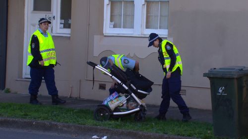 Police inspect the pram in Five Dock, Sydney.