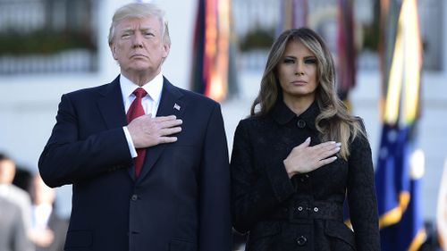 President Donald Trump and First Lady Melania Trump observe a minute silence at the White House. (AFP)