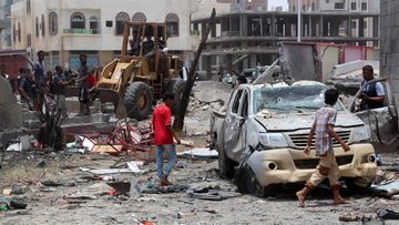 Yemenis inspect the site of a suicide car bombing claimed by the Islamic State group on August 29, 2016 at an army recruitment centre in the southern Yemeni city of Aden. (AFP)