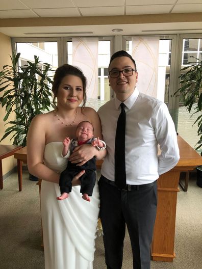 Bride carries premature baby down aisle at wedding