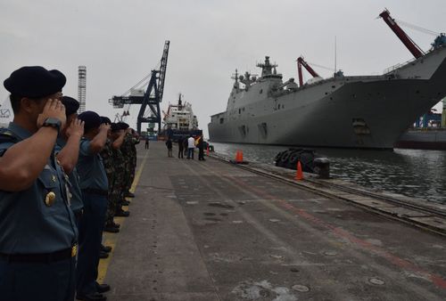 Indonesian military personnel salute the HMAS Adelaide when it visited Jakarta last year.