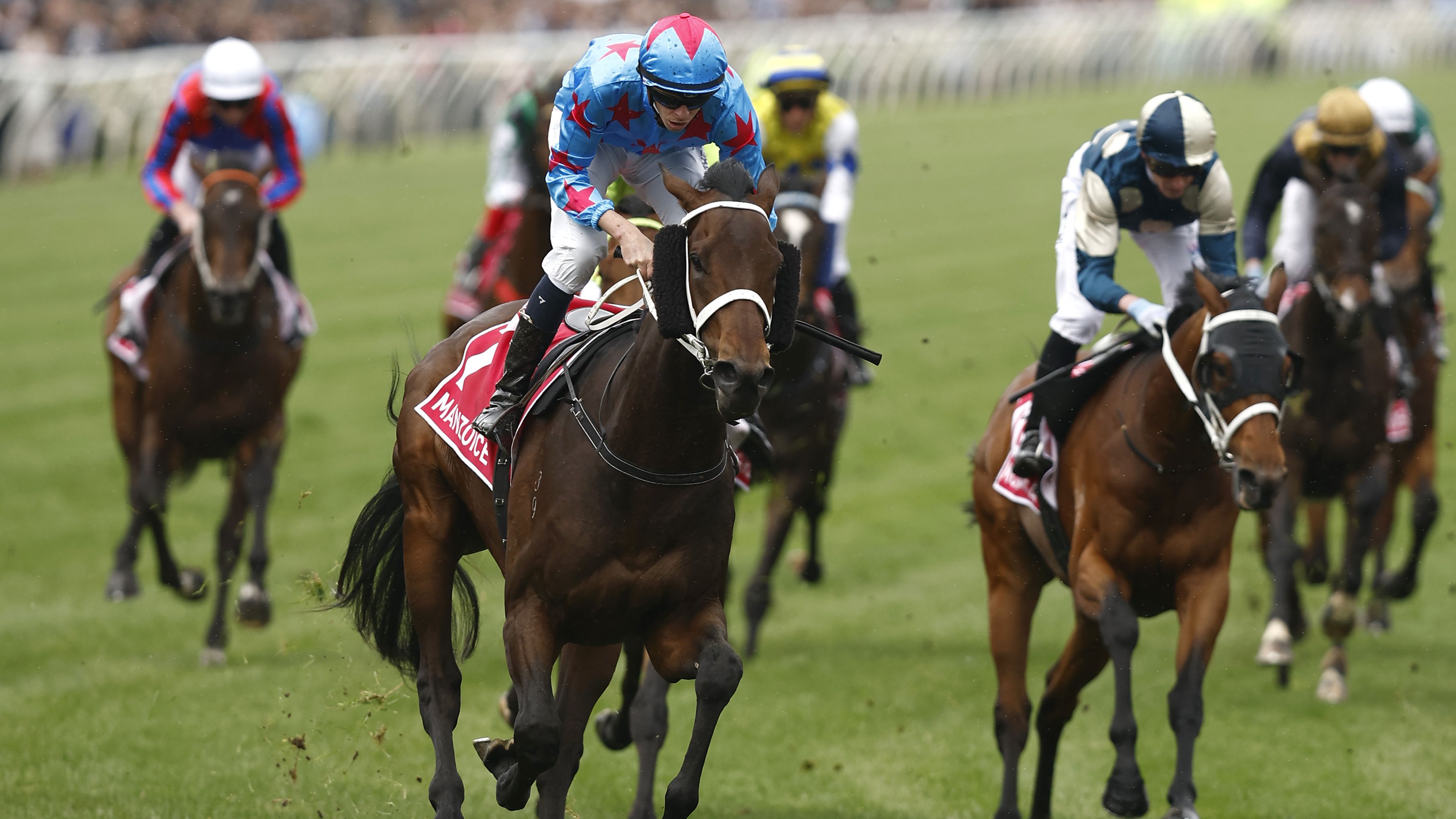 Jockey Michael Dee rides Manzoice to win the Victoria Derby.