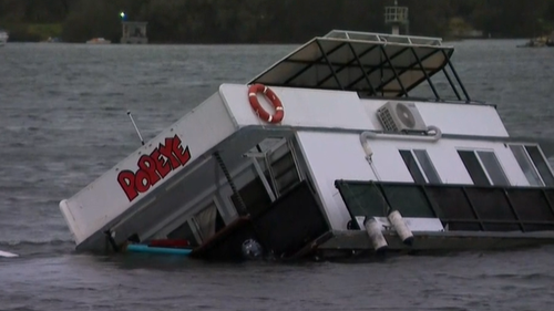 Wing gusts moved this houseboat in Gold Coast left to right after it sunk in wild weather.