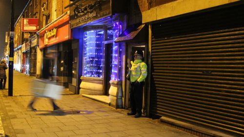 An officer guards a unit in Birmingham reportedly linked to the London attack. (AAP)