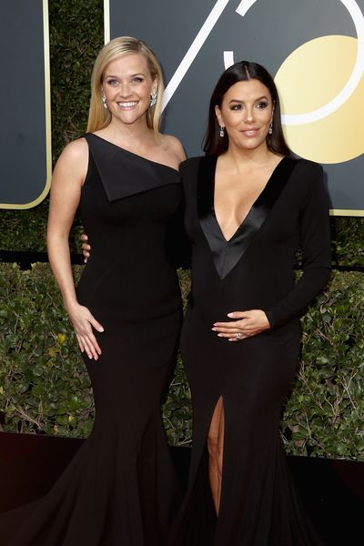 Actresses Reese Witherspoon in custom-made Zac Posen and Eva Longoria in Genny
