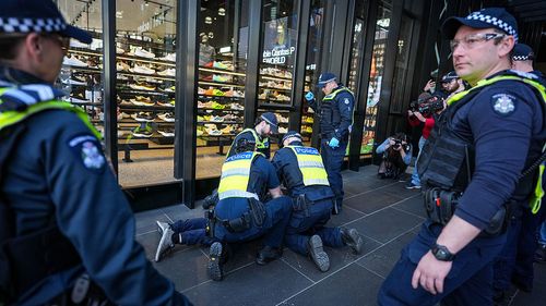 MELBOURNE, AUSTRALIA - AUGUST 03: Police detain counter-protesters during a march in support of Palestinians on August 03, 2025 in Melbourne, Australia. Protesters in Sydney and Melbourne joined marches and actions globally, as pressure mounts on the Israeli government over a devastating humanitarian crisis unfolding as its war against Hamas continues. (Photo by Asanka Ratnayake/Getty Images)