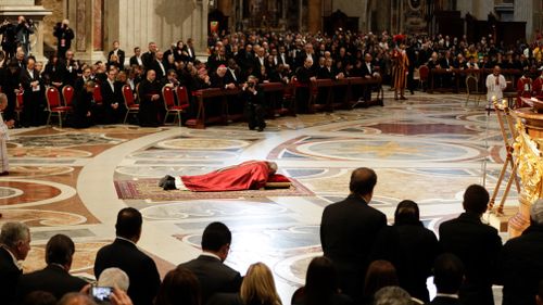 Pope Francis lies down in prayer during the Good Friday Passion of Christ Mass inside St. Peter's Basilica, at the Vatican. (AP)