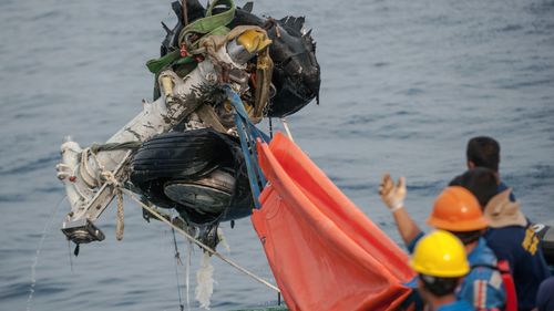 Rescuers use crane to retrieve part of the landing gears of the crashed Lion Air jet from the sea floor in the waters of Tanjung Karawang, Indonesia