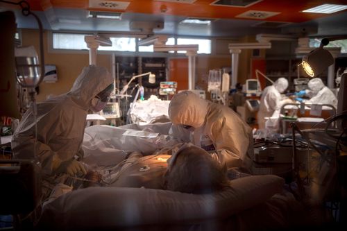Doctors treat COVID-19 patients in an intensive care unit in Rome, Italy. 