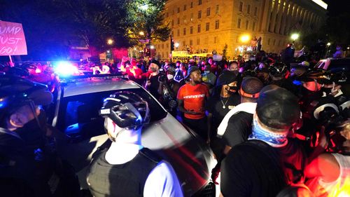 Protesters surround the White House as Donald Trump gives his speech.