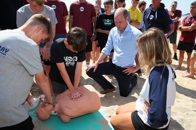 Prince William, the Duke of Cornwall, watches members of Hollywell Bay Surf Life Saving Club practice Cardiopulmonary resuscitation (CPR), during a visit to Fistral Beach on May 9, 2024 in Newquay, Cornwall.