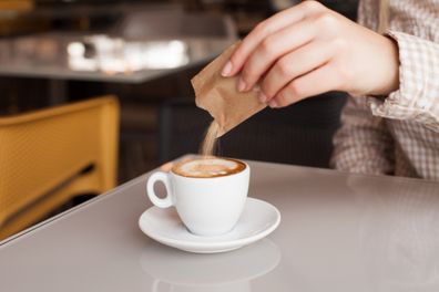 Picture of female hands with coffee and sugar