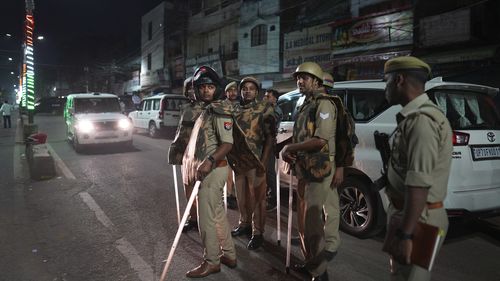 Policemen stand guard the area where gangster-turned-politician Atiq Ahmad and his brother Ashraf were shot, in, Prayagraj, India.