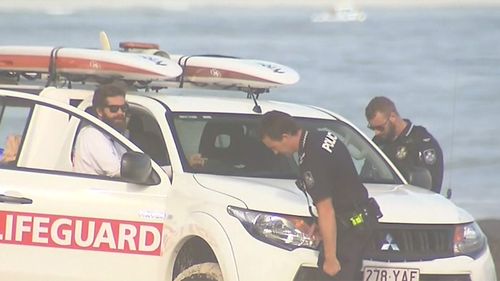 Police attend the scene where a surfer drowned this morning.