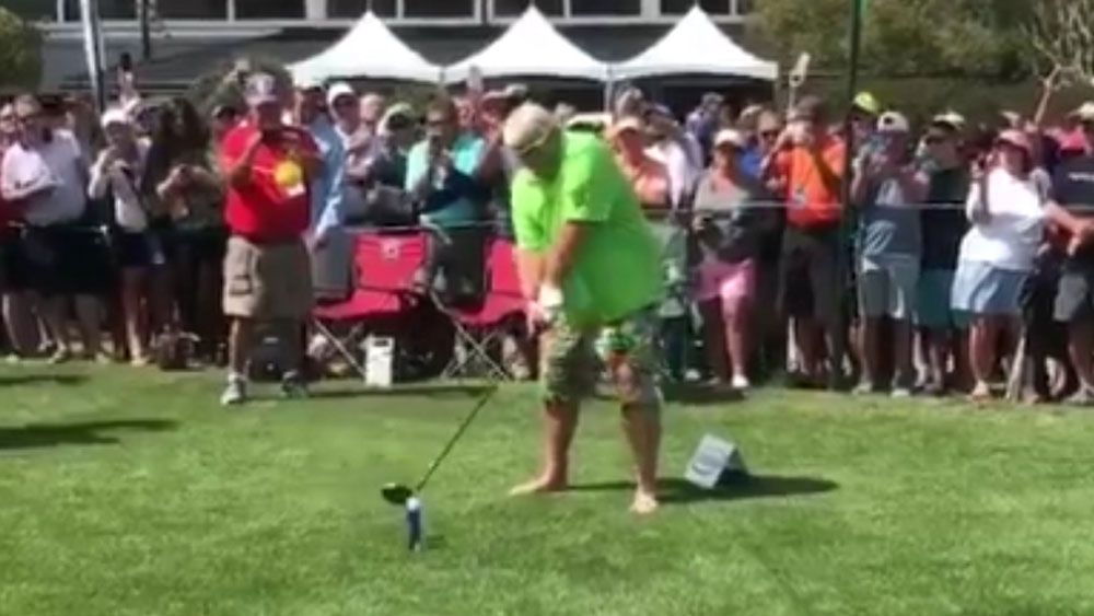 American golfer John Daly smokes and chugs a beer at celebrity Pro-Am