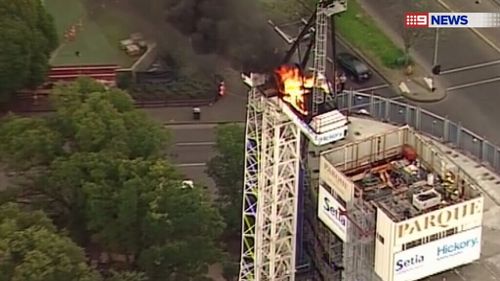 The crane caught fire at around 3.30pm. (9NEWS)