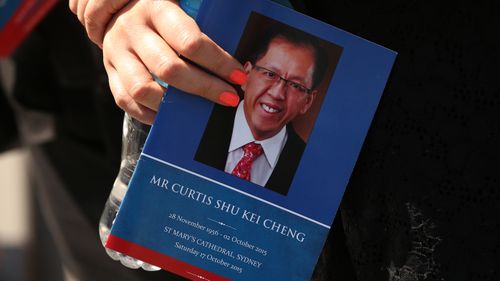 A woman holds an order of service for Curtis Cheng after his funeral service at St Mary's Cathedral, Sydney. Saturday, Oct. 17, 2015.