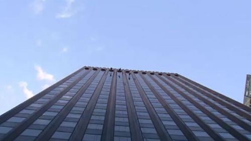 The group abseiled down the 113-metre high St James building in Melbourne's CBD. (9NEWS)