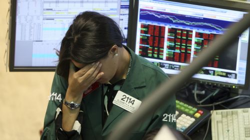 A specialist with Lehman Brothers works her post on the trading floor in September 2008. (AAP)