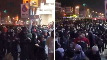 These images made from a Sunday, January 12, 2020, video provided by the New York-based Center for Human Rights in Iran, shows police firing tear gas into a crowd in Tehran.