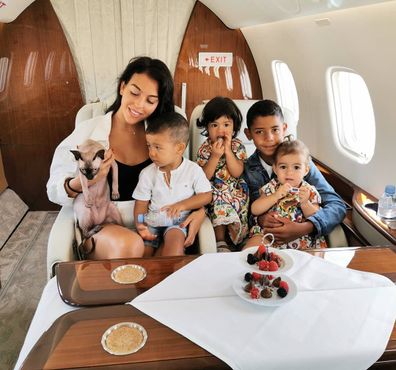 Cristiano Ronald's family poses with their Sphynx cat on a private jet.