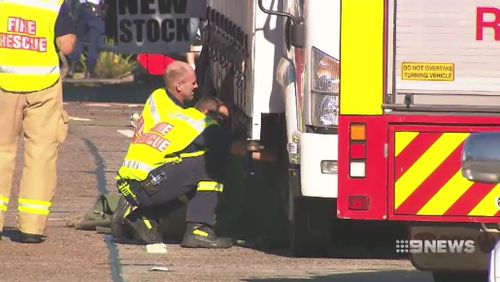 Emergency crews inspect one of the trucks involved in the crash. Picture: 9NEWS