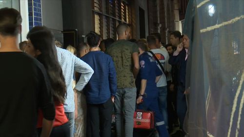 Partygoers lined up outside a bar on George Street in Sydney's CBD.