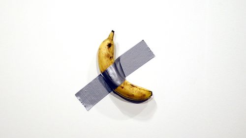 Italian artist Maurizio Cattelan's piece 'Comedian' (a banana duct taped to the wall) is shown during Art Basel in Miami, Florida, USA.