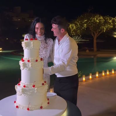 April Love Geary and Robin Thicke cut their wedding cake
