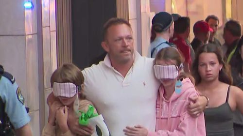 One father was seen covering his children's eyes as he led them away from ﻿what was unfolding while another father grabbed his daughter and hid in the Cotton On Kids store.