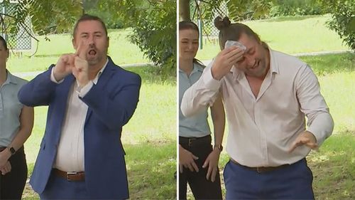 AUSLAN interpreter Mikey Webb took off his jacket, wiped his brow and got back to work.