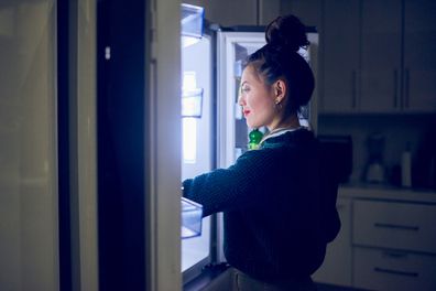 Cropped shot of an attractive young woman looking in her fridge for a midnight snack at home