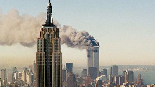 The World Trade Centre burns behind New York City's Empire State Building, Sept. 11, 2001.