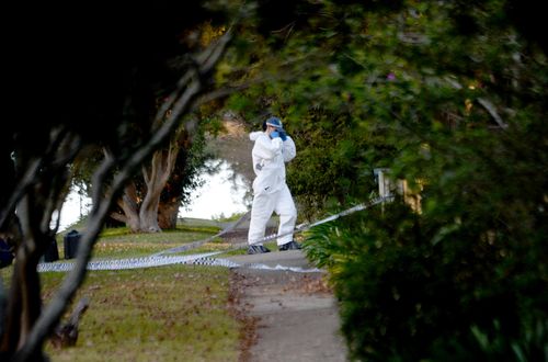 A forensic officer stands outside the home where the teenagers were killed. Picture: AAP