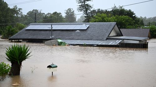 Homes were inundated by flood water yesterday in Goodna, west of Brisbane.