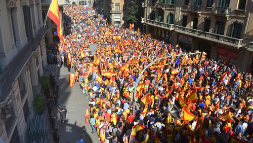 Ten of thousands of flag-waving demonstrators packed central Barcelona to rally against plans by separatist leaders to declare Catalonia independent. (AAP)