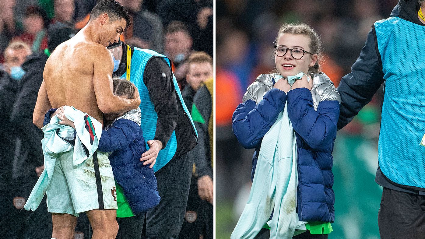 Cristiano Ronaldo with young fan gifts jersey during Portugal World Cup  qualifier with Ireland