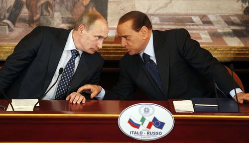 Vladimir Putin and Silvio Berlusconi speak.