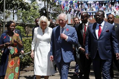 King Charles III, centre, and Queen Camilla, centre left, arrive to visit the Eastlands Library to learn about a project that restores old libraries and encourages reading amongst children in the community in Makadara district of Nairobi, Tuesday, Oct. 31, 2023.  