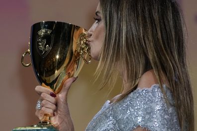 Penelope Cruz kisses the Coppa Volpi Best Actress award for 'Parallel Mothers' onstage at the closing ceremony during the 78th edition of the Venice Film Festival in Venice, Italy.  Sept, 11, 2021