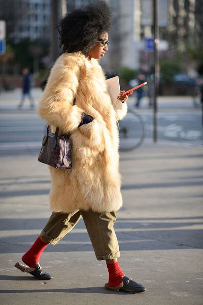 Julia Sarr Jamois pairs the omnipresent fur-lined Gucci
loafers with red socks and a fur chubby.