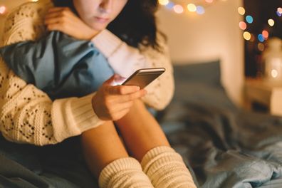 Girl texting on smartphone at home