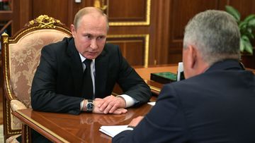 Russian president Vladimir Putin listens to a report of Defence Minister Sergei Shoigu about fire inside deep water mini-submarine.