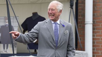  Prince Charles, Prince of Wales laughs during a visit with Camilla, Duchess of Cornwall to the Turnbull & Asser shirt factory on July 9, 2020 in Gloucester, United Kingdom